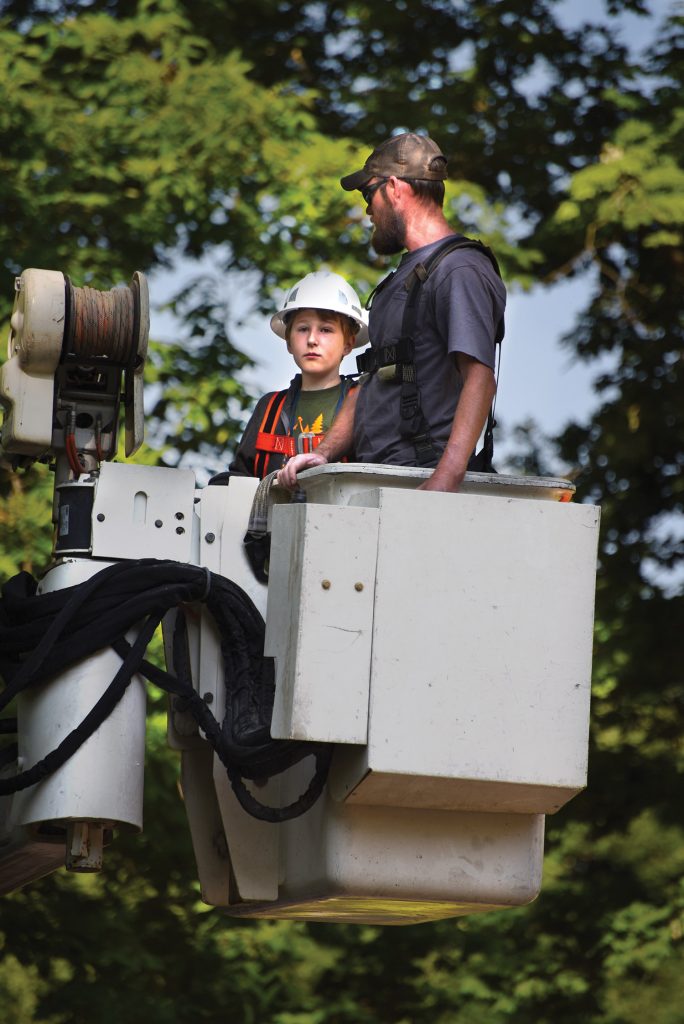 Camp Kilowatt camper in a bucket truck