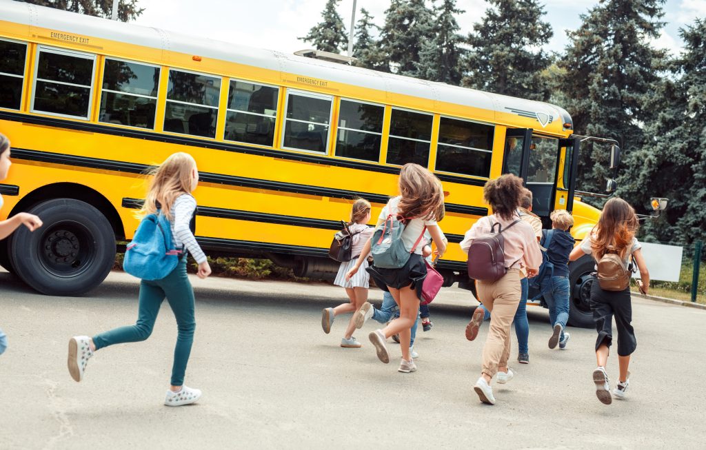 Kids getting on a school bus