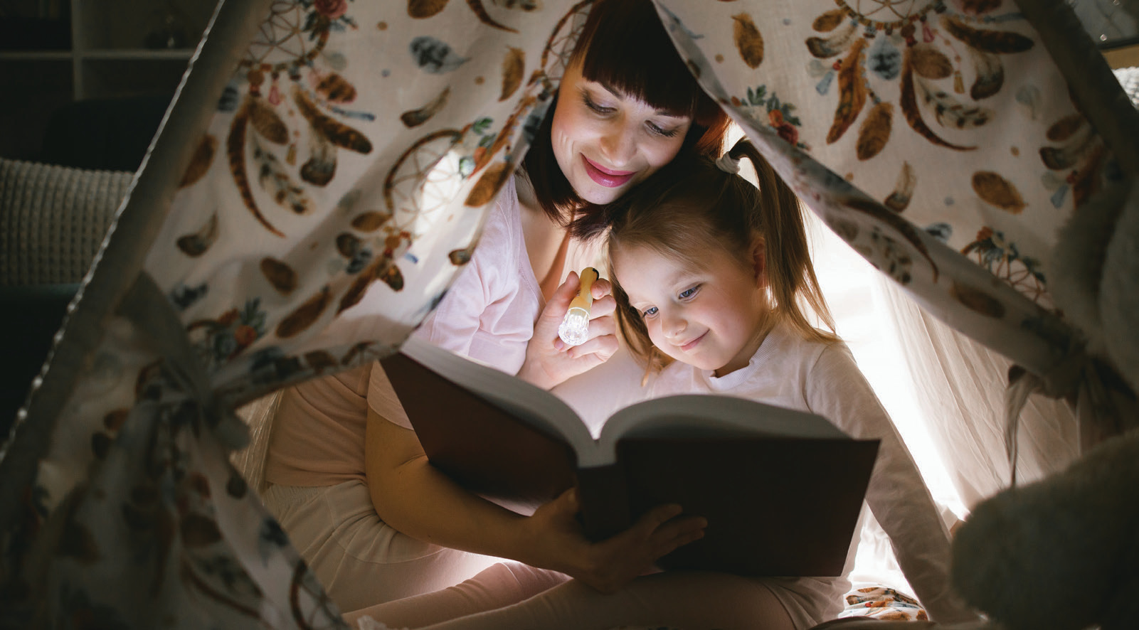 Mother and child reading in a fort