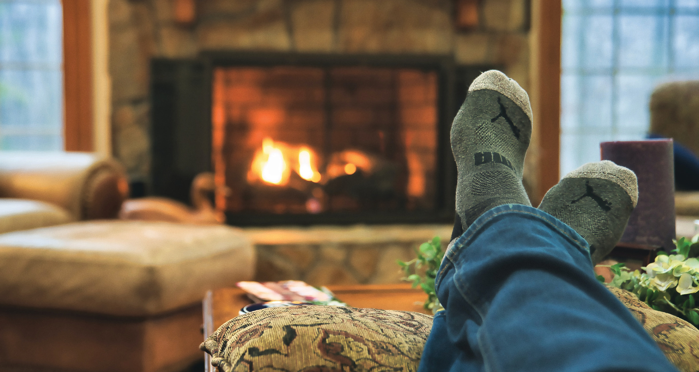 Person in socks in front of a fire
