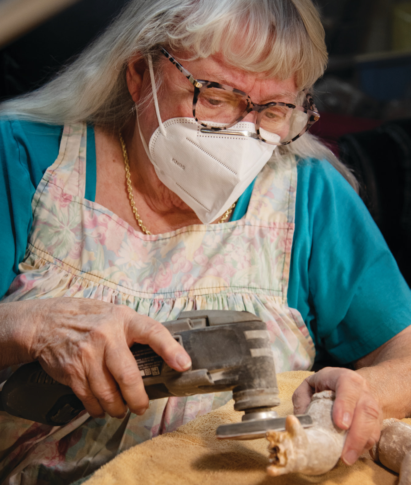 Lavonne McCarty repairs a doll