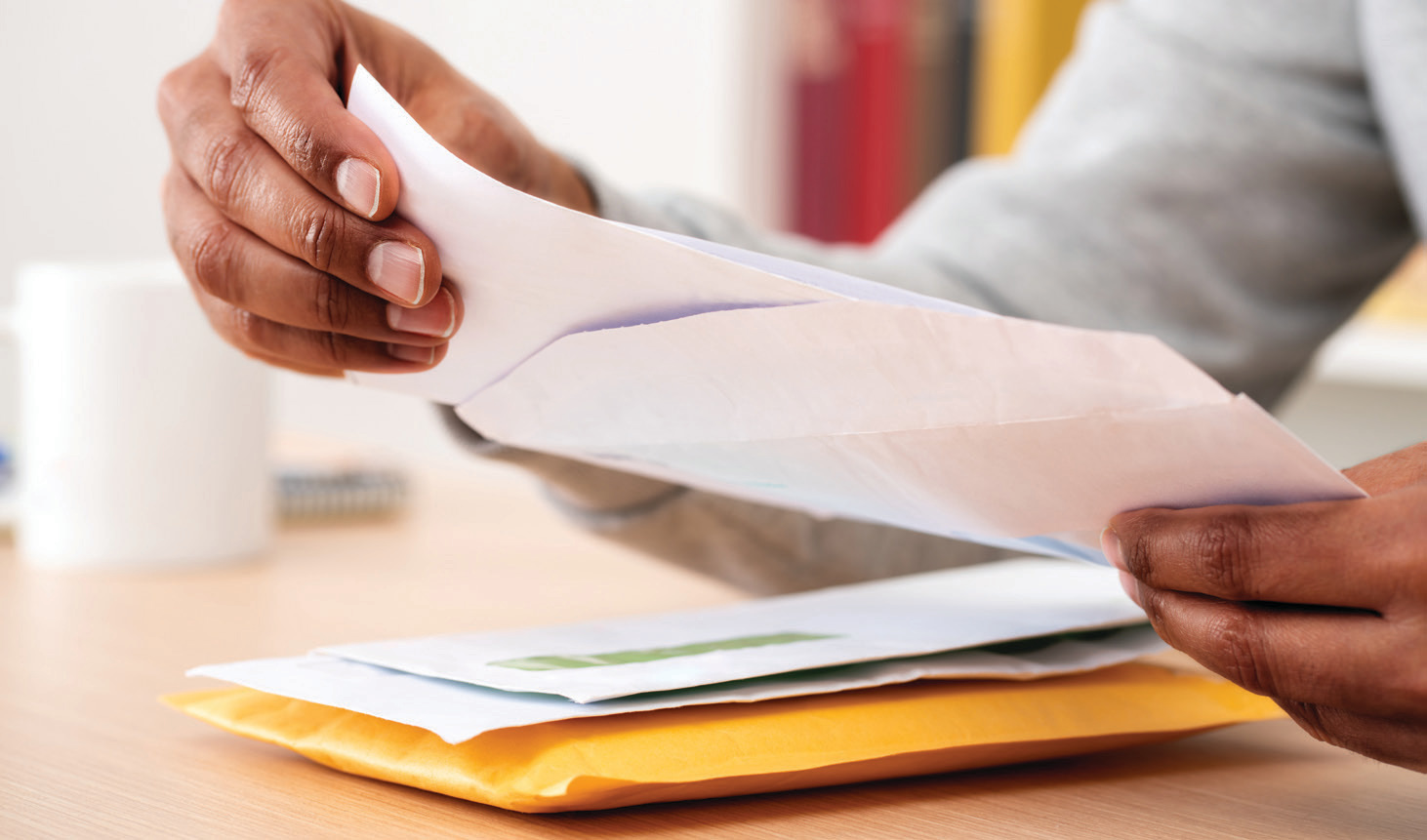 Man taking something out of an envelope