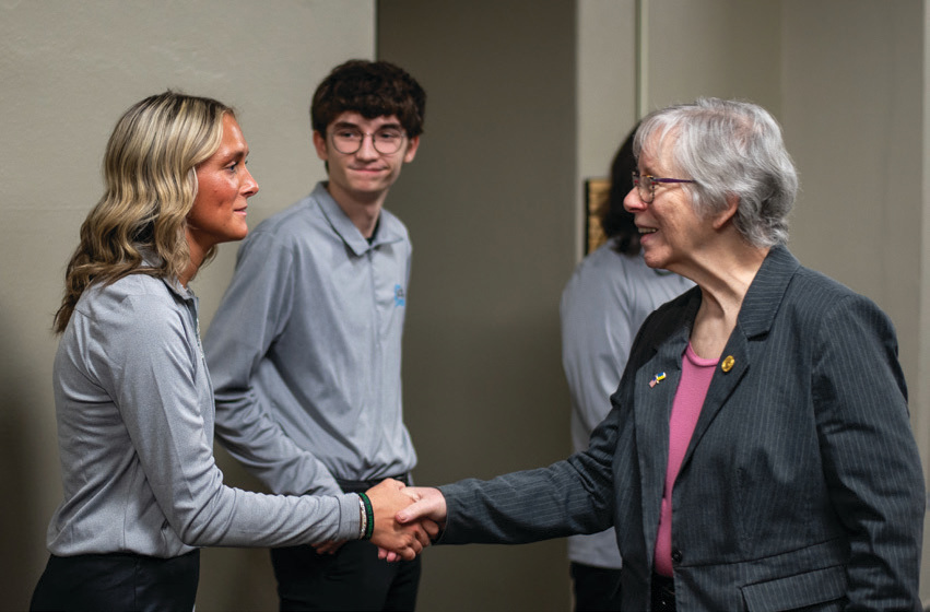 Junior Board member Caloe Peretti shakes hands with Representative Boy.