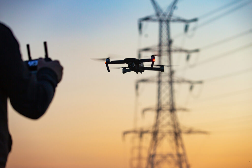 Person flying a drone near power lines