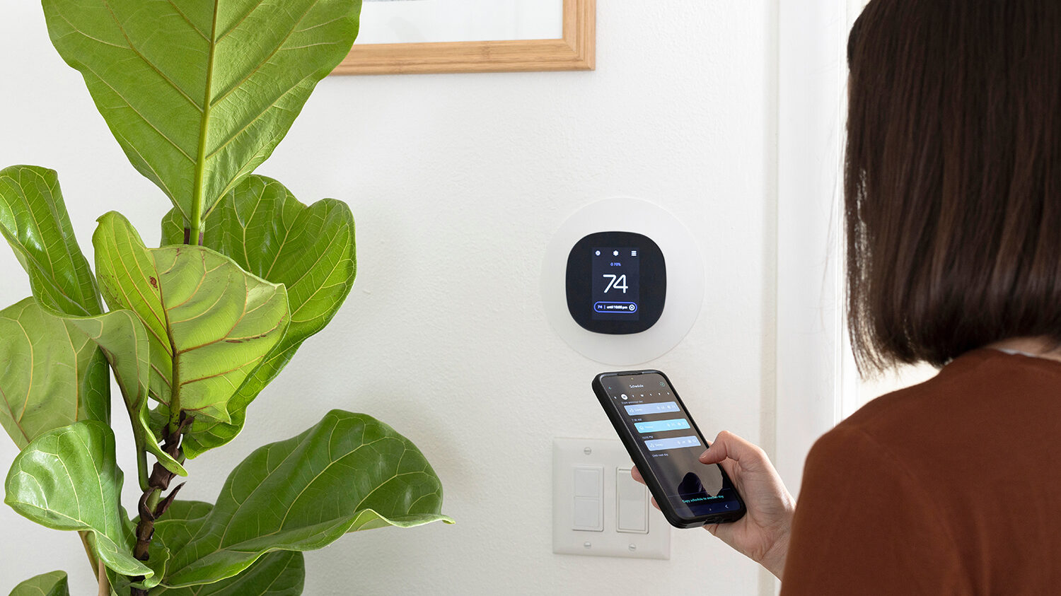 Woman with smart thermostat