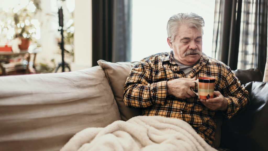 Man in blanket with tea