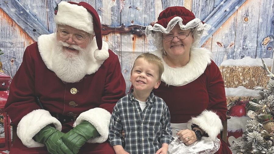 Santa and Mrs. Claus with kid