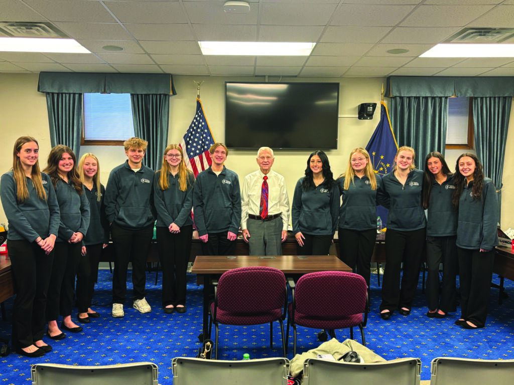 Sen. Ed Charbonneau poses with the students after discussing key issues being addressed during the current legislative session.