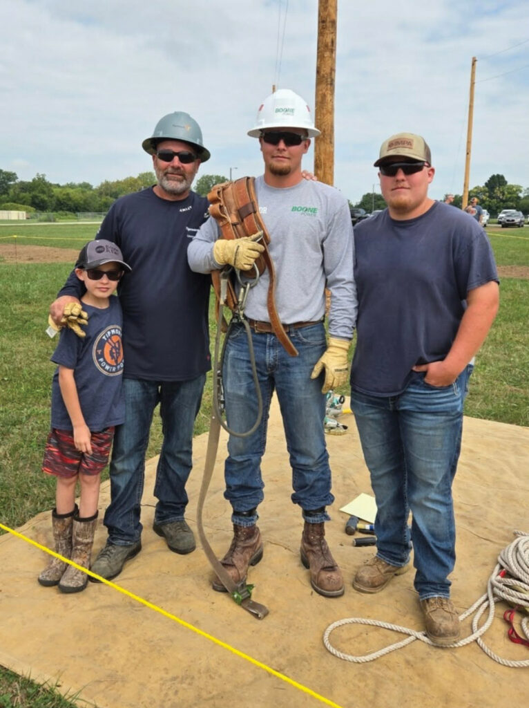 Bobby Taylor Jr. with his three sons (left to right) Cole, Ryan, and Robby at the 2025 Indiana Electric Cooperative Lineman Rodeo.