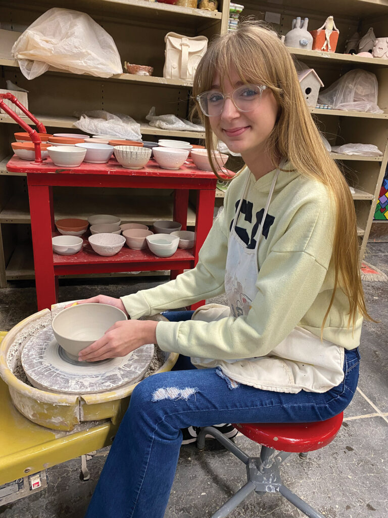 A Tell City High School student throws a bowl on a pottery wheel.