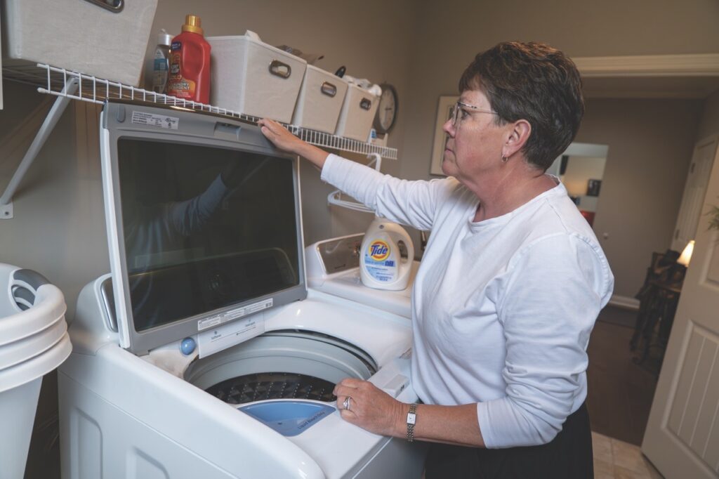 Woman using washing machine