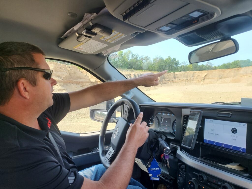 imi Aggregate Area Manager Jason Murphy points to the worksite while describing the rigorous testing methods.