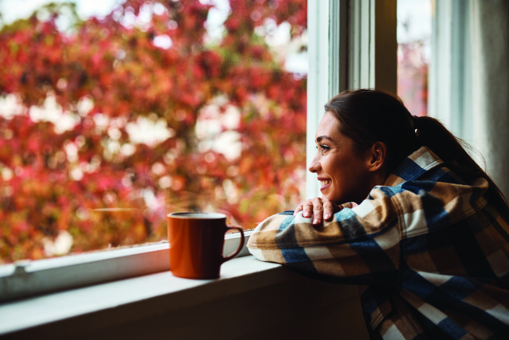 Woman drinking coffee in fall