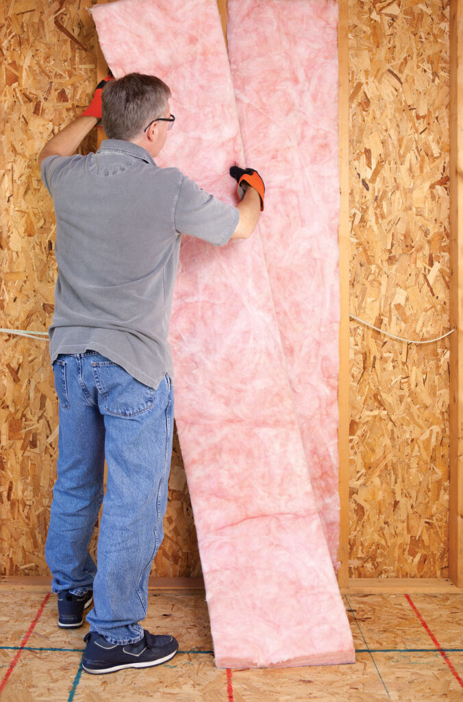 Man installing insulation