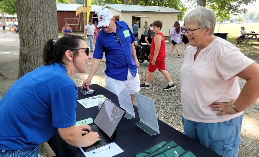 Kelly Spear, Noble REMC director of communications, registers a member for her free ice cream voucher at the Noble County Community Fair.