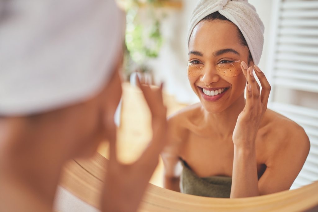 Woman in bathroom applying makeup