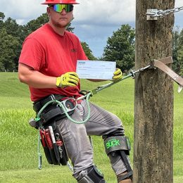 Logan Englert with his scholarship award at the North American Lineman Training Center.