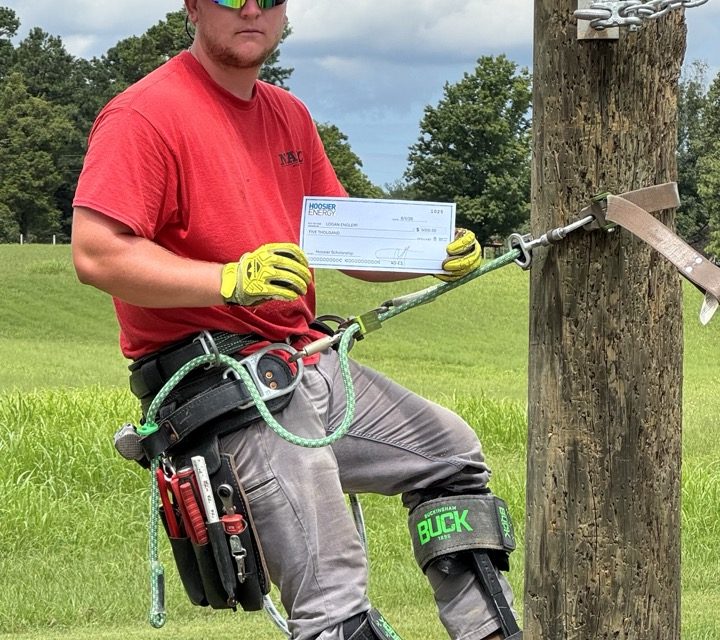 Logan Englert with his scholarship award at the North American Lineman Training Center.